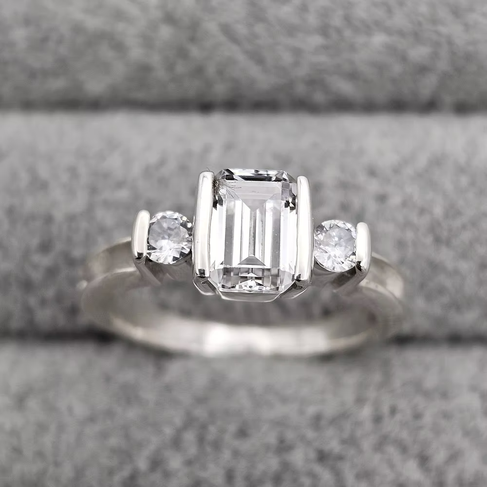MEMORIAL EMERALD CUT TRIPLE CZ BEZEL RING