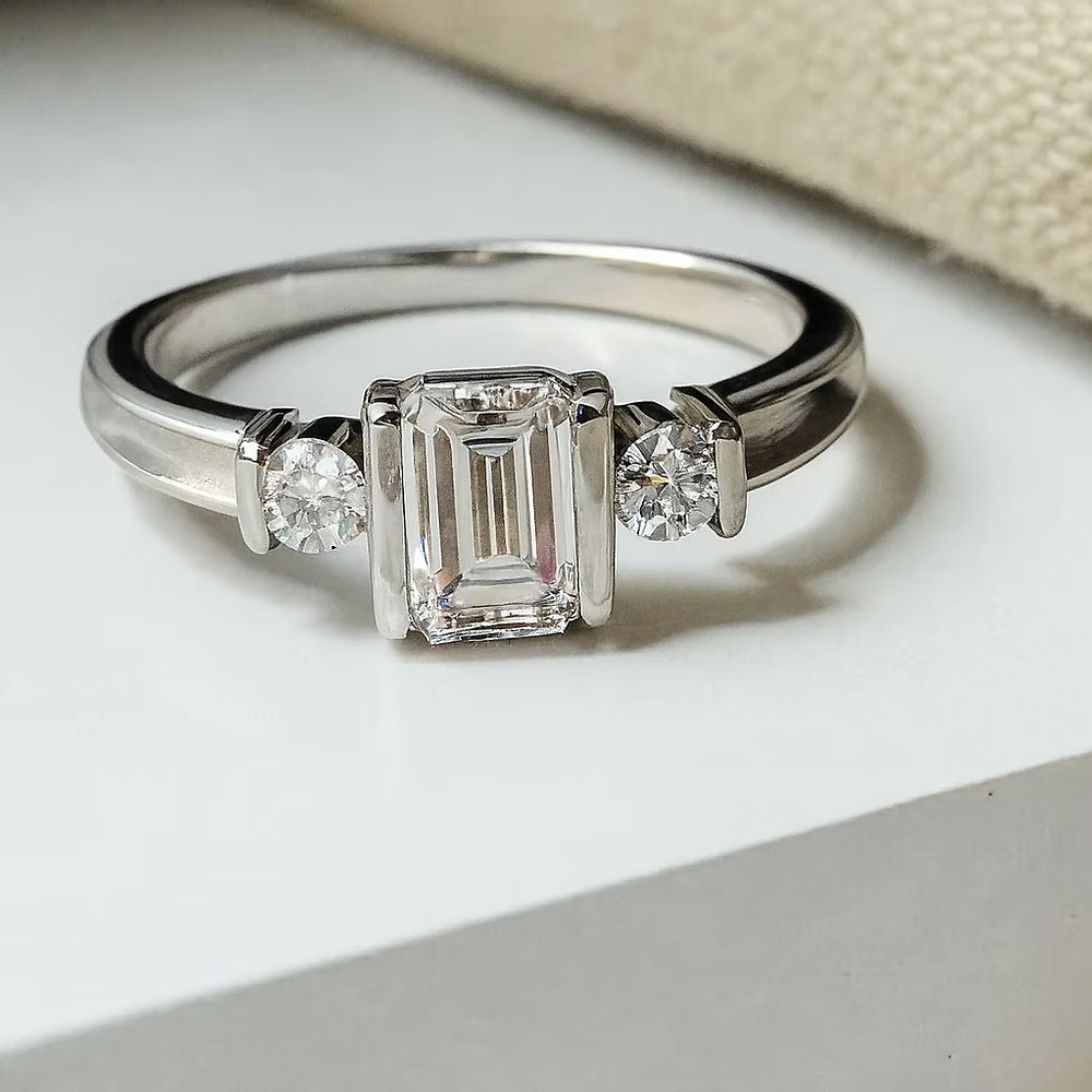 MEMORIAL EMERALD CUT TRIPLE CZ BEZEL RING