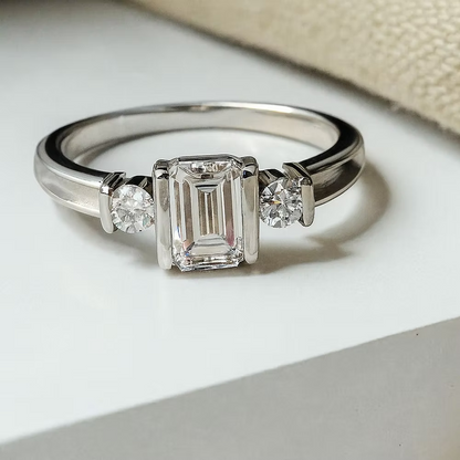 MEMORIAL EMERALD CUT TRIPLE CZ BEZEL RING