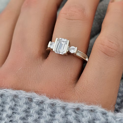 MEMORIAL EMERALD CUT TRIPLE CZ BEZEL RING